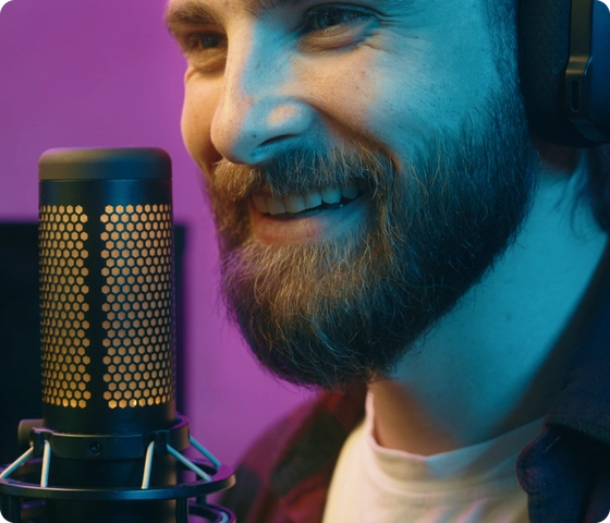 A voice talent recording in front of a studio microphone