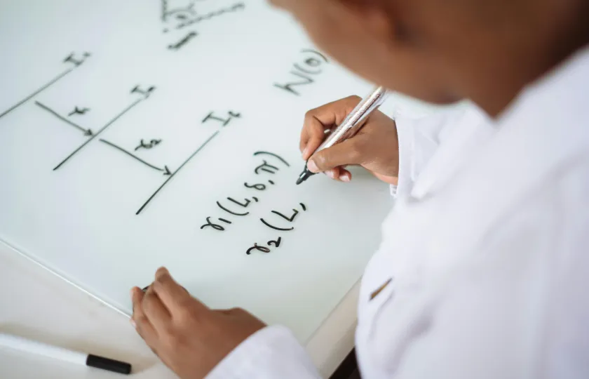 Person deriving formula on white board - improve STEM accessibility with text to speech for math