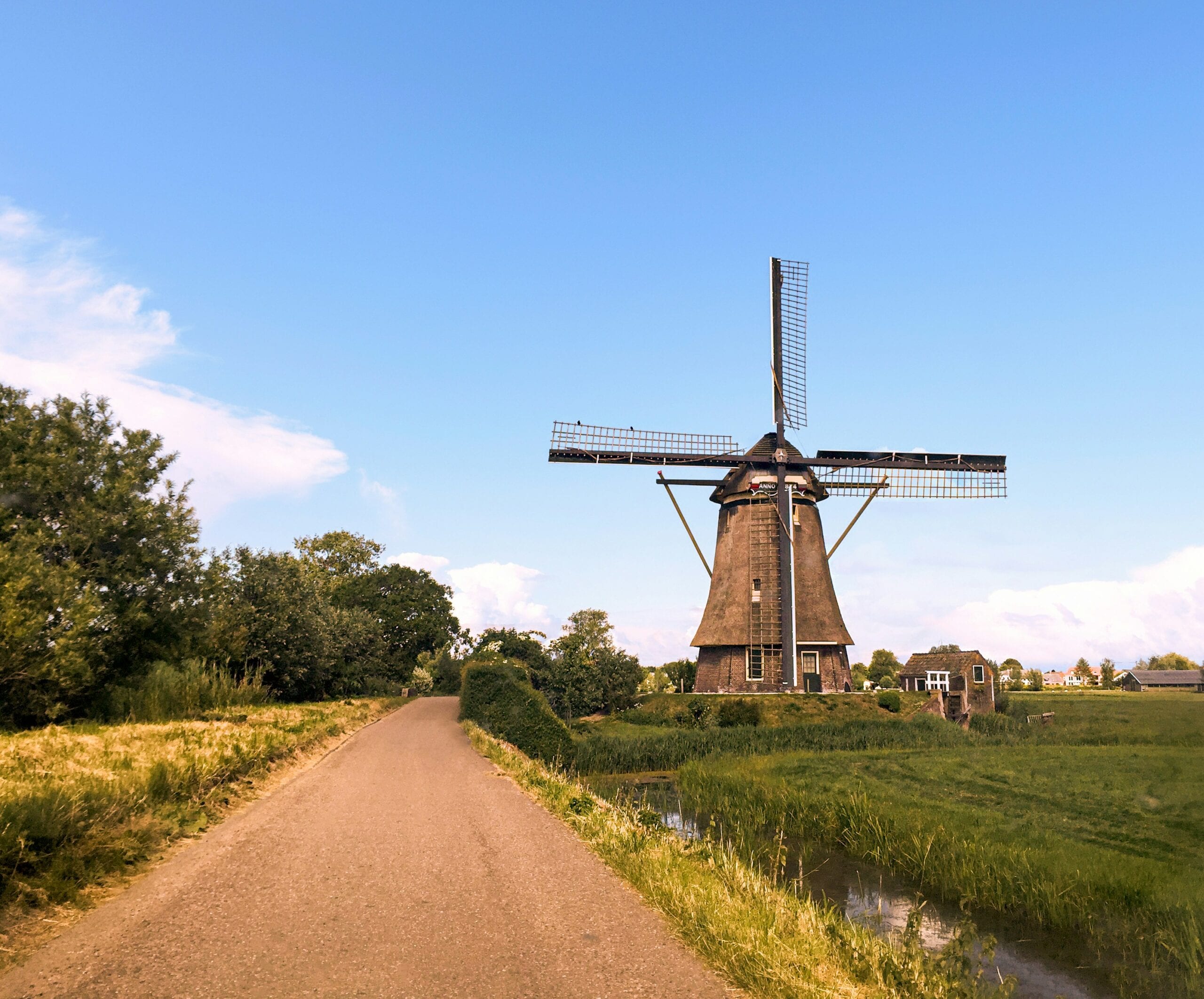 A windmill on the side of a country road