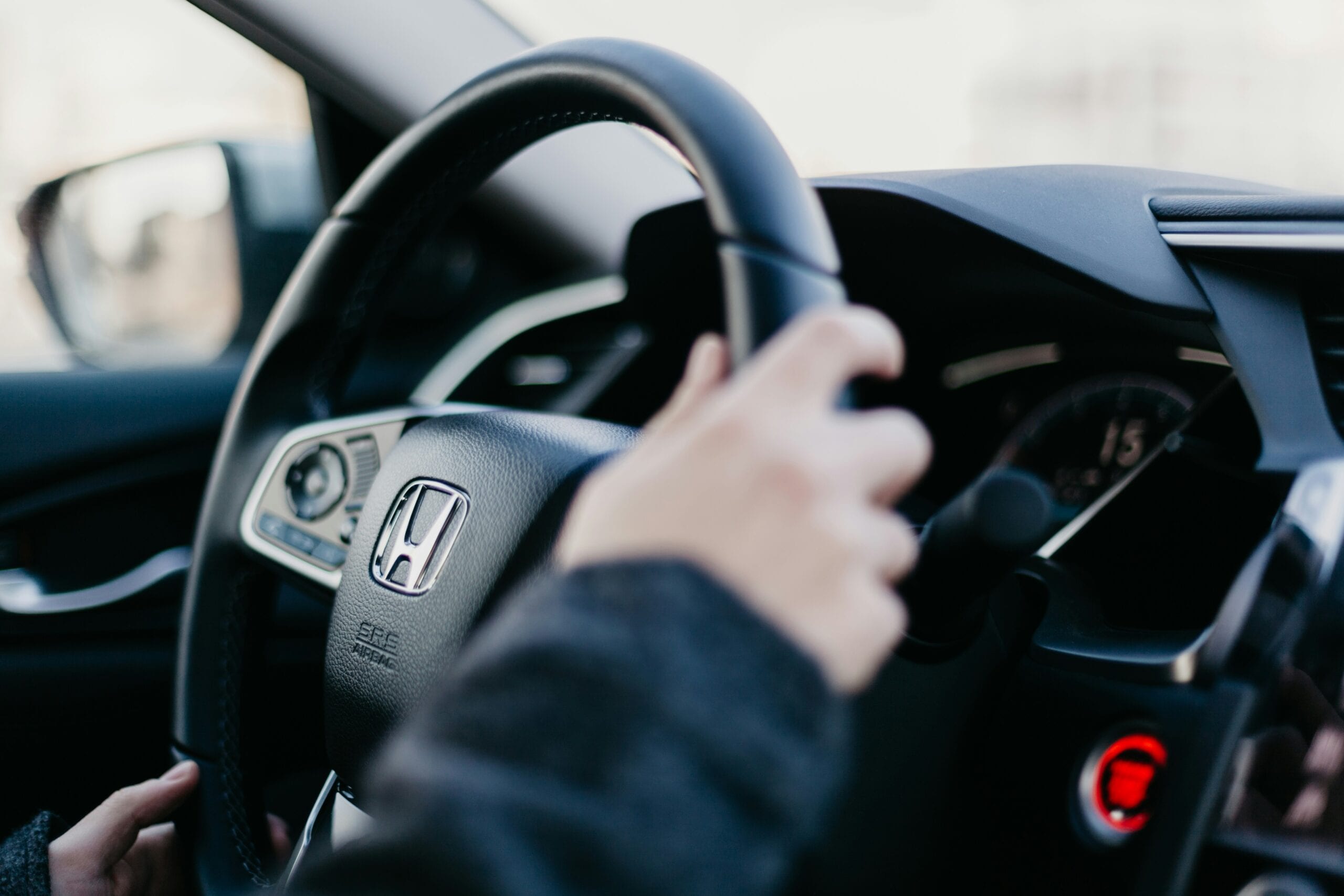 The steering wheel of a Honda car