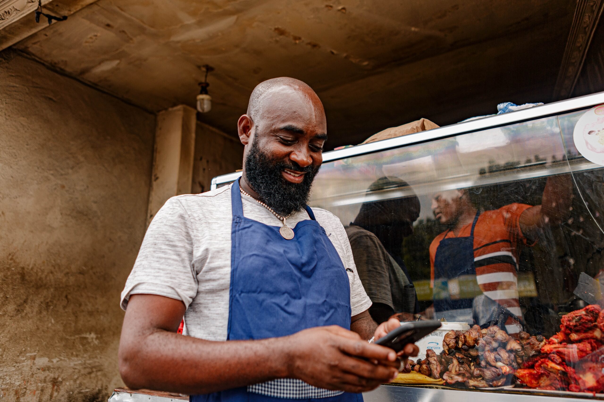 A market trader using a handheld device