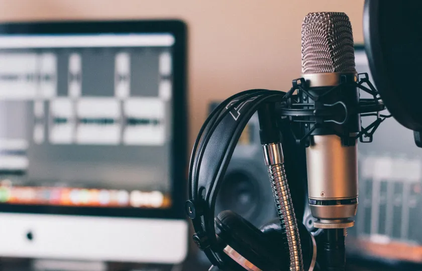 Headphones and microphone on the stand while adding a voice over in Adobe Captivate