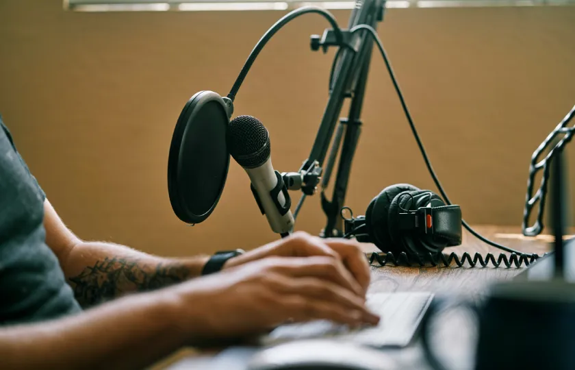 Person holding microphone adding an audio file to Articulate Storyline 360 course