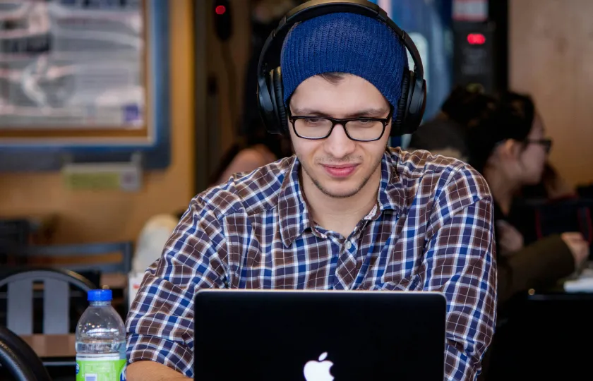 Man wearing headphones learns how ReadSpeaker TTS works with Anthology Ally (formerly Blackboard Ally)