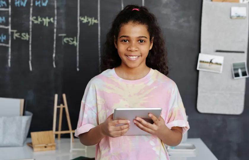 A student with a tablet using text-to-speech tools for education: Speechify Vs. ReadSpeaker