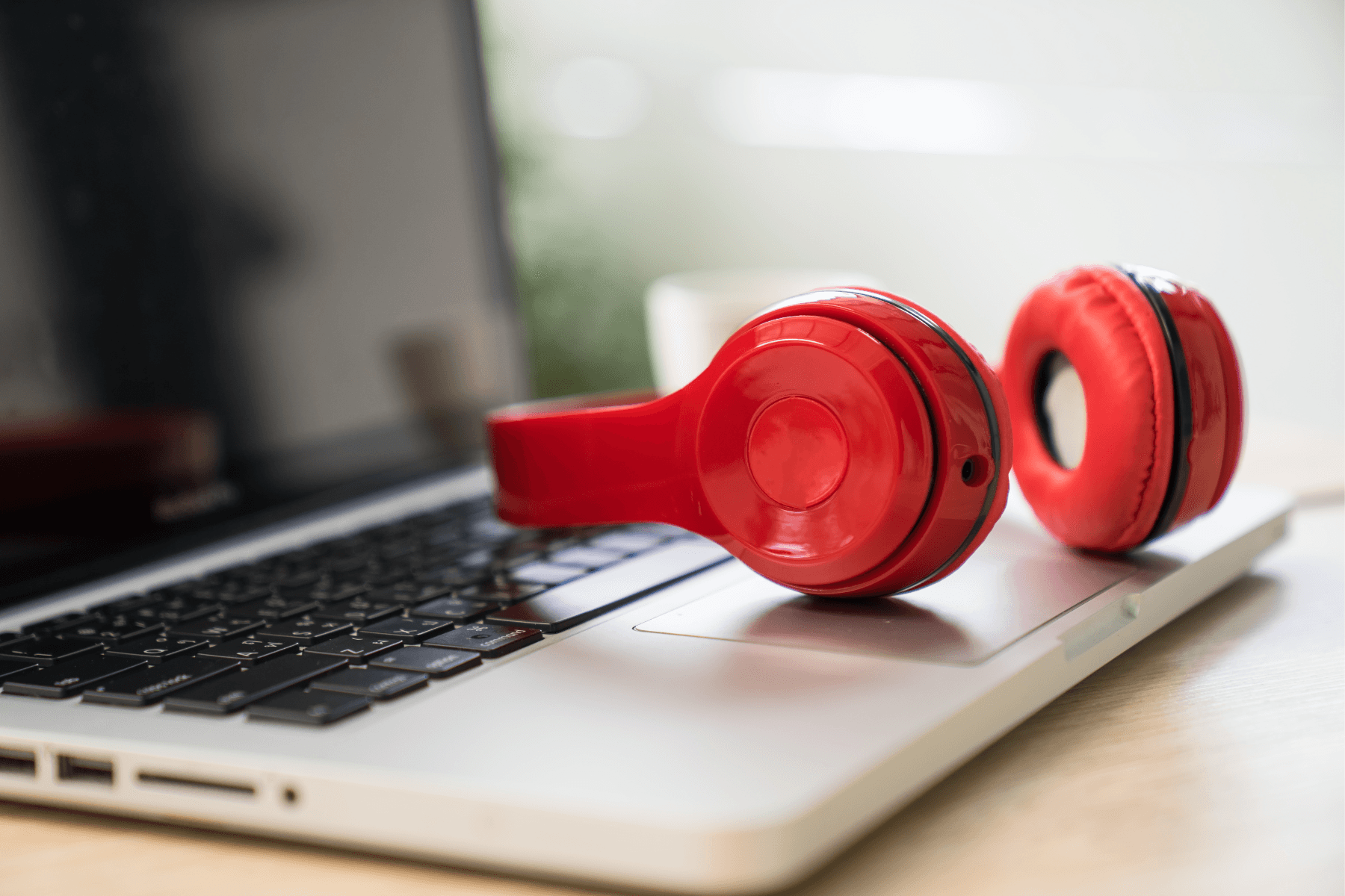 Red headphones on a laptop.