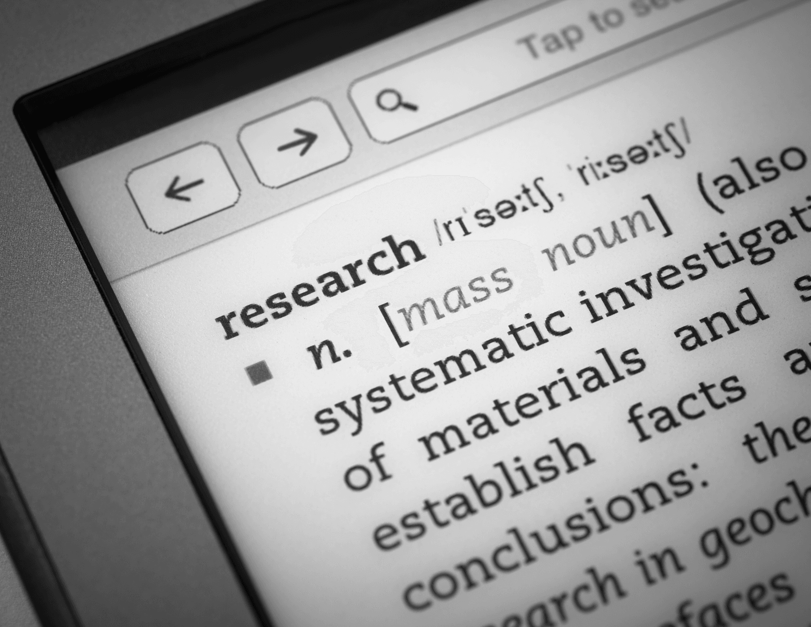 A close-up of a dictionary entry for the word research