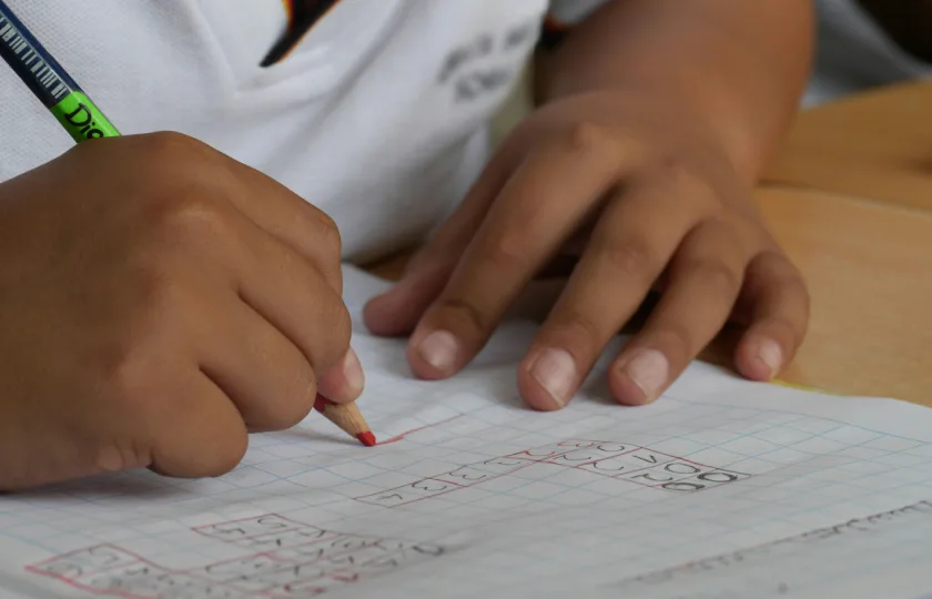 A student writing in a white graphing notebook. Inclusive education in the UAE: the role of EdTech