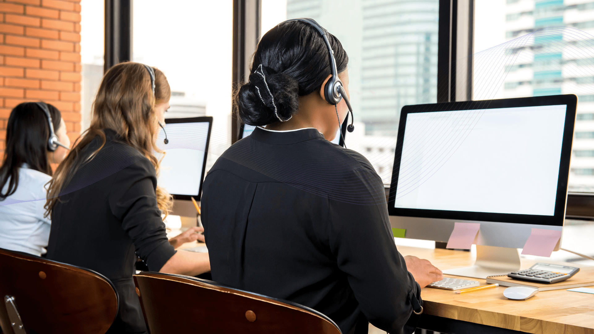 People with headsets use computers.