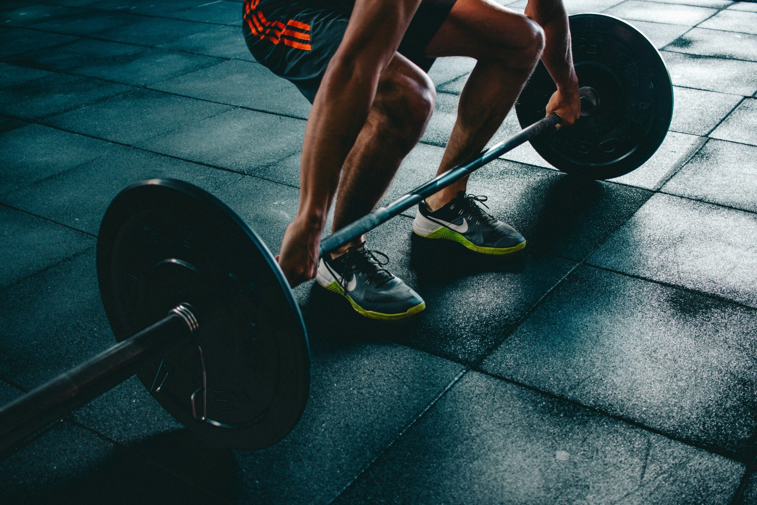 A weightlifter gripping a loaded barbell