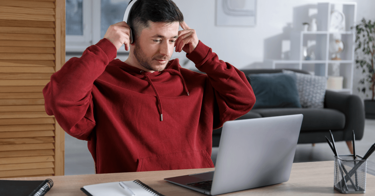 Man with headphones using a laptop.