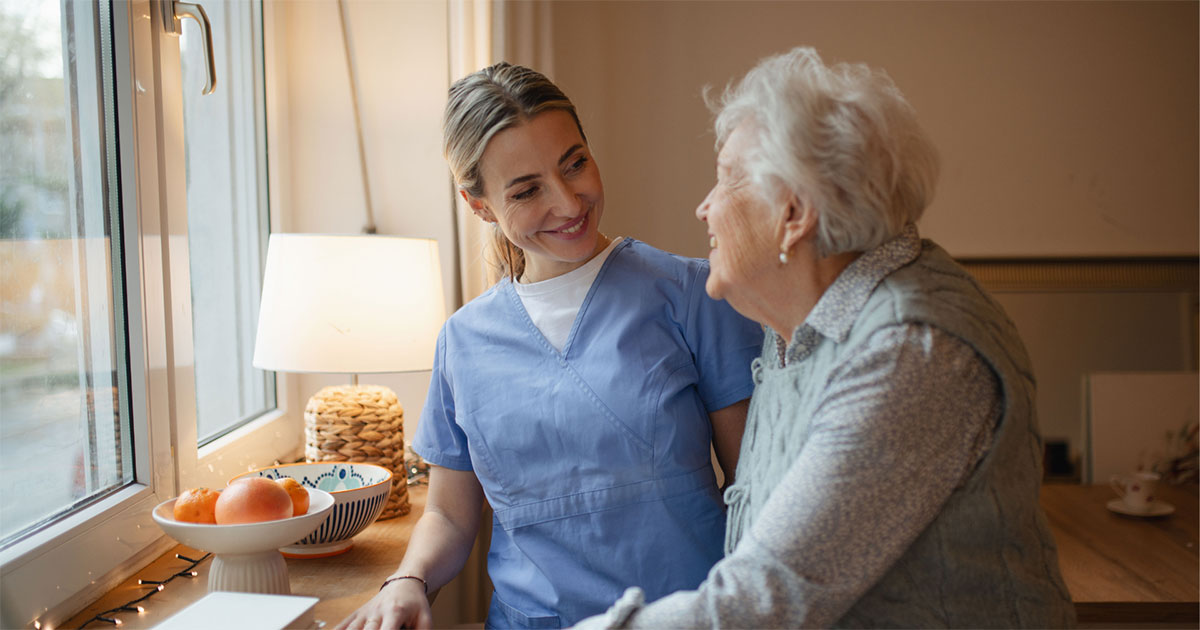 A care worker talking with an elderly woman