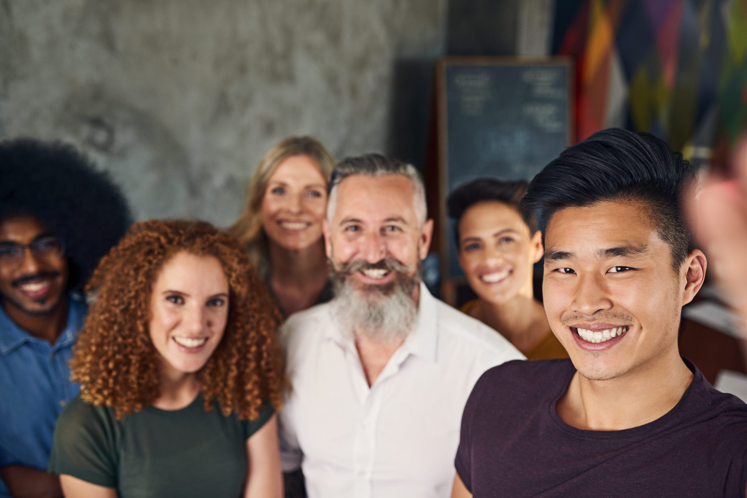 Group of smiling diverse team members at work.