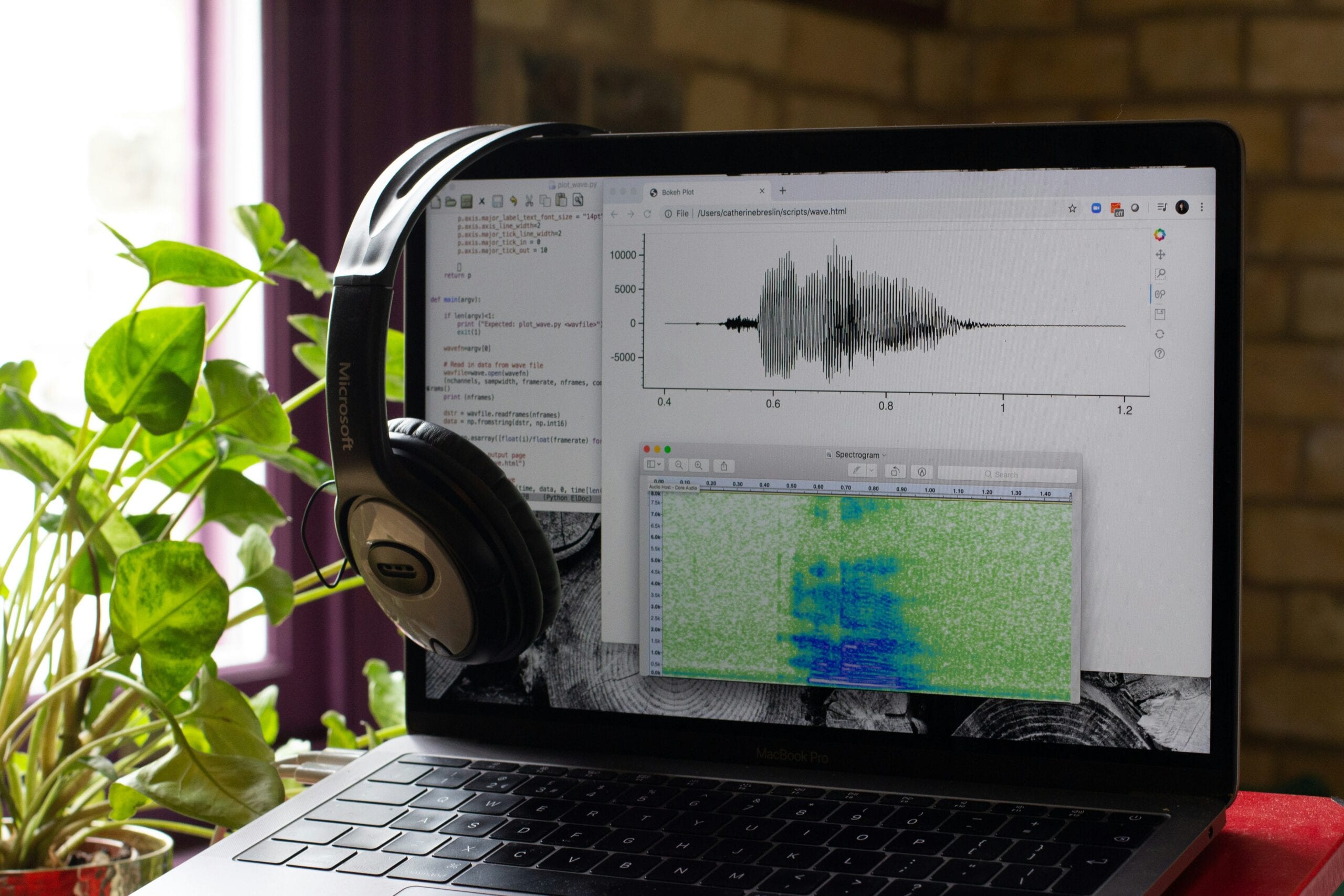 An open laptop showing soundwaves, representing spoken audio.