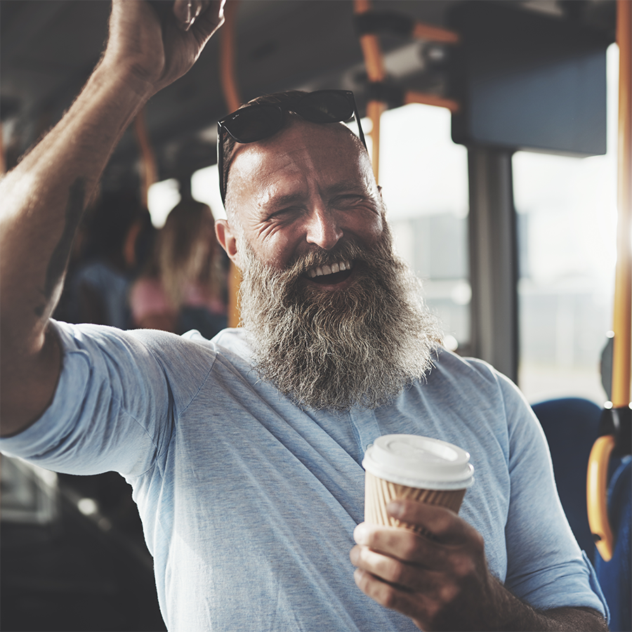 Man with a coffee taking the bus