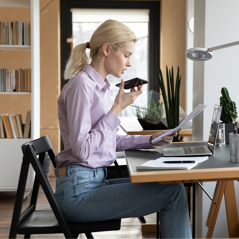 Woman working at desk with virtual assistant
