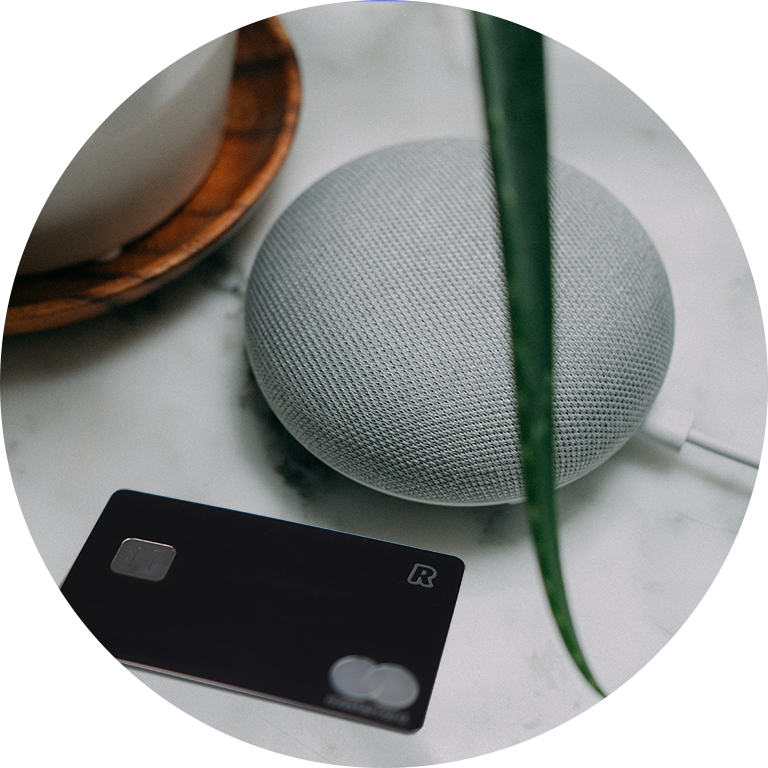 Photograph of a smart speaker and credit card on a table