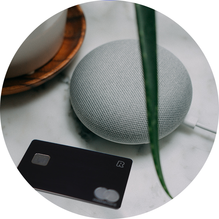Photograph of a smart speaker and credit card on a table