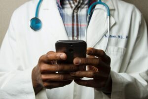 A doctor holding a smartphone in his hands