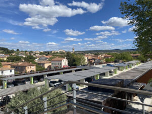 View from the roof of an outdoor car park with panoramic solar panels.