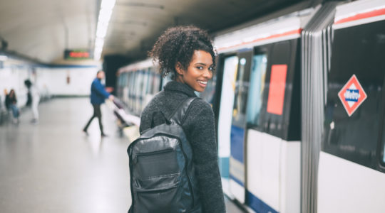 Smiling woman about to board a train