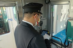 Conductor manages opnboard announcement system on Sanyo Electric Railway