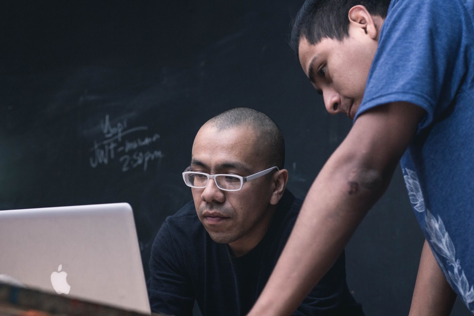 Two higher education students in front of a computer