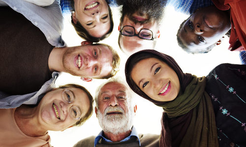 Concept of ReadSpeaker multilingual Neural TTS expressed via image of people of different cultures in a circle looking down ,